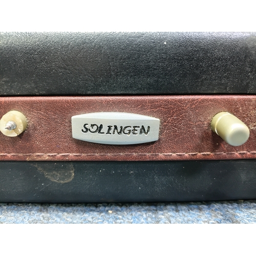 31 - A vintage Breitenbach Solingen deluxe cutlery set housed in a locking briefcase with a certificate a... 