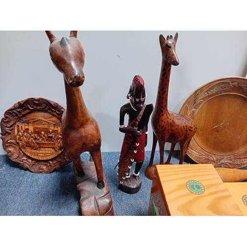 32 - A collection of decorative wooden items including carved figures of animals , people , dishes and a ... 