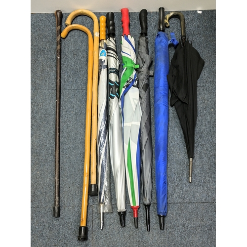 40 - A collection of walking sticks and umbrellas, with brands such as Dunlop, Lambert and Butler, Burtel... 
