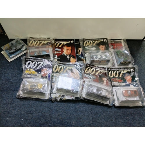 151 - A collection of 007 James bond magazine and cars some of which include; citron 2cv, BMW z8, lotus es... 