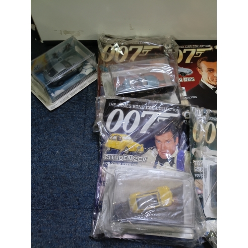 151 - A collection of 007 James bond magazine and cars some of which include; citron 2cv, BMW z8, lotus es... 