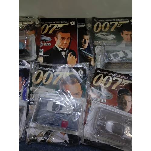 151 - A collection of 007 James bond magazine and cars some of which include; citron 2cv, BMW z8, lotus es... 