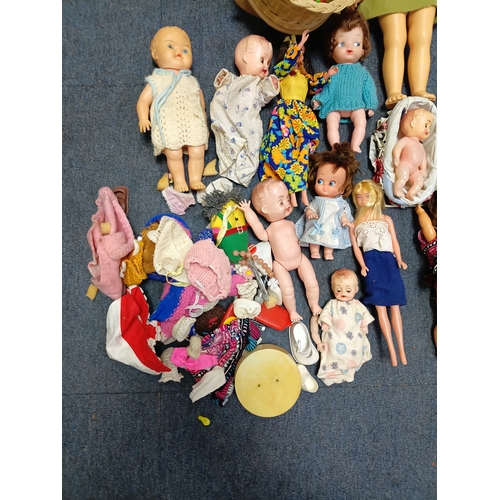 153 - A job lot of dolls and barbies with accessories such as clothes, shoes, hairclips and more.