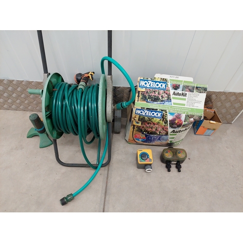 46 - A hozelock deluxe auto kit together with hose reel and sprinkler attachment. All appears present in ... 
