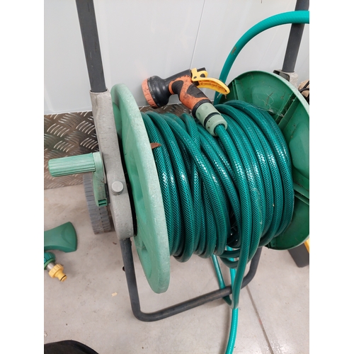 46 - A hozelock deluxe auto kit together with hose reel and sprinkler attachment. All appears present in ... 