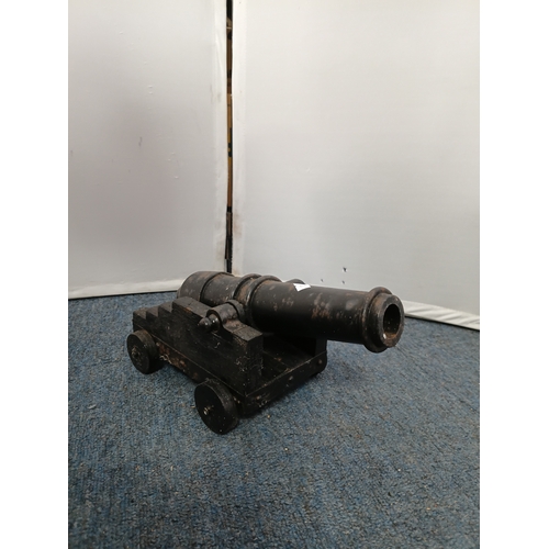 227 - A vintage model 17th century naval cannon with cast iron barrel and wooden carriage together with A ... 