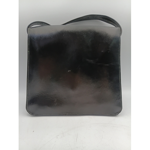 33 - A pair of vintage black handbags and a strap. The largest one measures height 9 inches x width 9.5 i... 