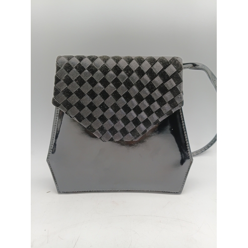 33 - A pair of vintage black handbags and a strap. The largest one measures height 9 inches x width 9.5 i... 