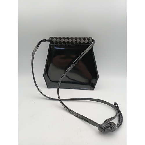 33 - A pair of vintage black handbags and a strap. The largest one measures height 9 inches x width 9.5 i... 