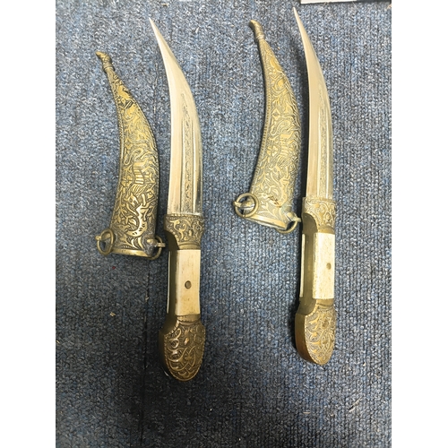 200 - A pair of middle Eastern brass and bone daggers with brass sheaths. Length 9.5 inches.
