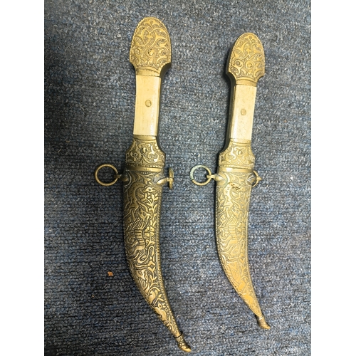 200 - A pair of middle Eastern brass and bone daggers with brass sheaths. Length 9.5 inches.