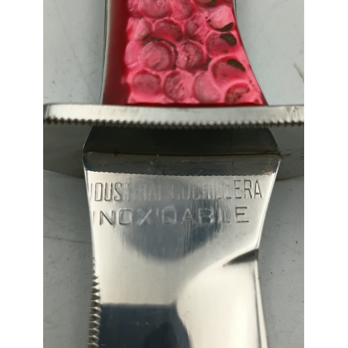 202 - A hunting knife with a 5inch stainless steel blade and a decorative pink handle with leather sheath.