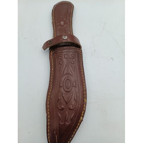 202 - A hunting knife with a 5inch stainless steel blade and a decorative pink handle with leather sheath.