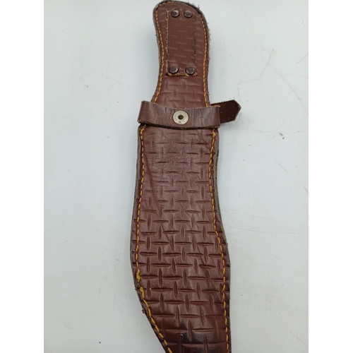 202 - A hunting knife with a 5inch stainless steel blade and a decorative pink handle with leather sheath.