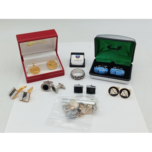 203 - A collection of vintage men's cufflinks of various designs; also included is a tie pin, ring and mor... 