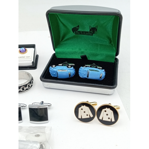 203 - A collection of vintage men's cufflinks of various designs; also included is a tie pin, ring and mor... 