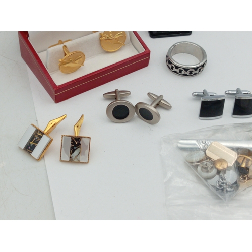 203 - A collection of vintage men's cufflinks of various designs; also included is a tie pin, ring and mor... 