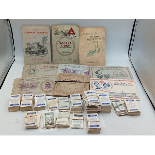 205 - A large collection of various vintage cigarette card albums and loose card sets, themes include; rai... 