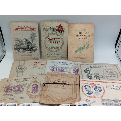 205 - A large collection of various vintage cigarette card albums and loose card sets, themes include; rai... 