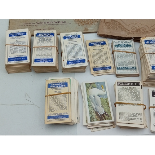 205 - A large collection of various vintage cigarette card albums and loose card sets, themes include; rai... 