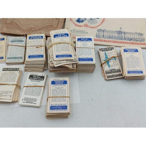 205 - A large collection of various vintage cigarette card albums and loose card sets, themes include; rai... 