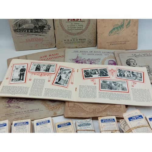 205 - A large collection of various vintage cigarette card albums and loose card sets, themes include; rai... 