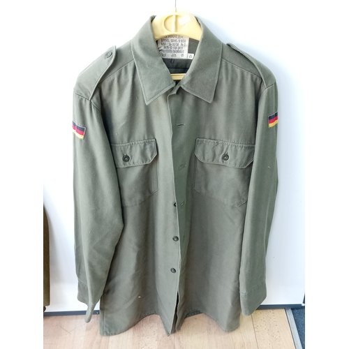 206 - A collection of vintage military uniforms, to include; a British Army No. 2 Dress jacket, a German 