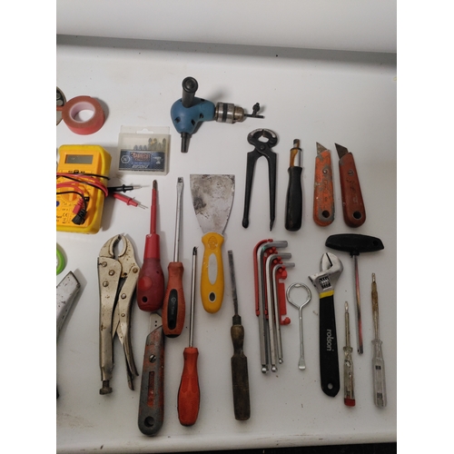 65 - A large collection of tools to include Stanley knifes, screwdrivers, scrapers, a hammer, pliers and ... 