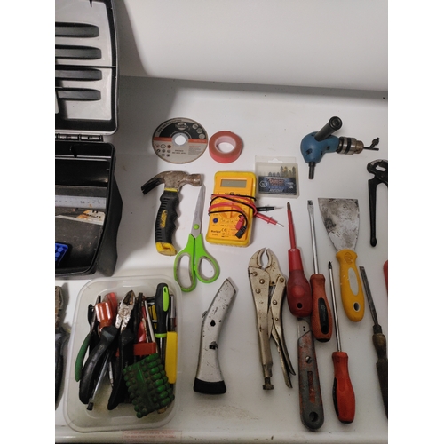 65 - A large collection of tools to include Stanley knifes, screwdrivers, scrapers, a hammer, pliers and ... 