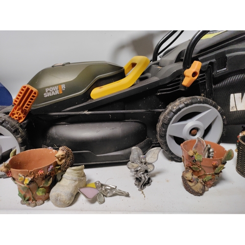 73 - A collection of garden items to include a WORX Cordless lawnmower working, plant pots, stakes and mo... 