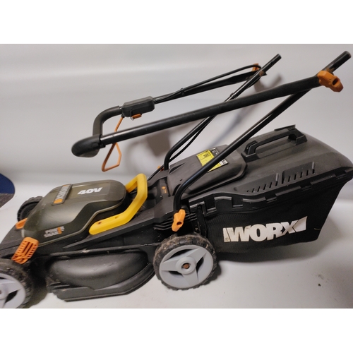 73 - A collection of garden items to include a WORX Cordless lawnmower working, plant pots, stakes and mo... 