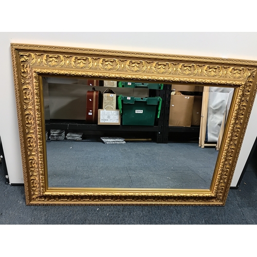 102 - A large bevelled edge gold gilt mirror. Height 28inches x width 38inches
