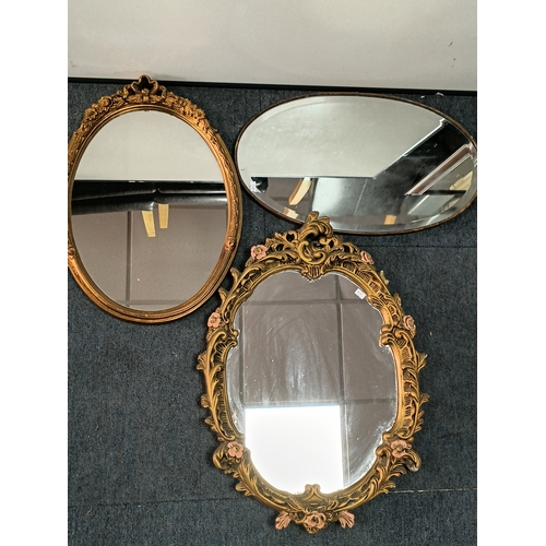 104 - A pair of vintage gold gilt mirrors and an oval shaped mirror. Largest measures Height 25inches x wi... 