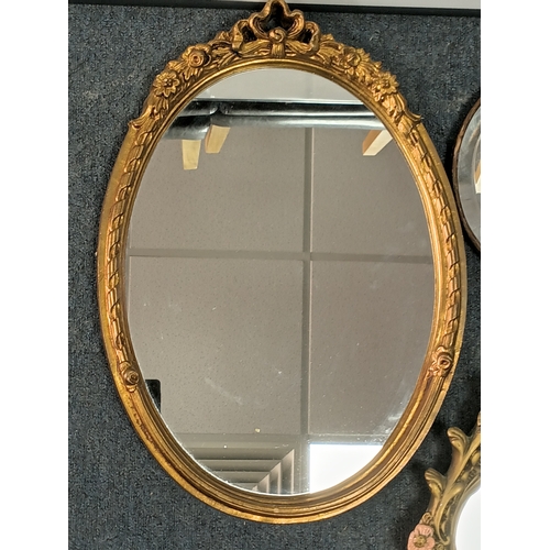 104 - A pair of vintage gold gilt mirrors and an oval shaped mirror. Largest measures Height 25inches x wi... 