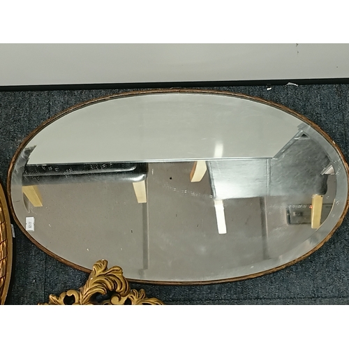 104 - A pair of vintage gold gilt mirrors and an oval shaped mirror. Largest measures Height 25inches x wi... 