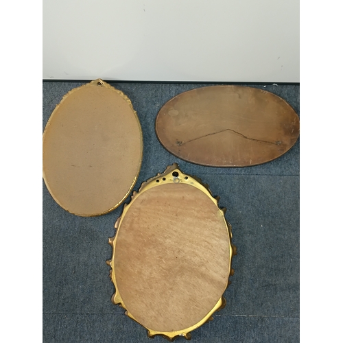 104 - A pair of vintage gold gilt mirrors and an oval shaped mirror. Largest measures Height 25inches x wi... 