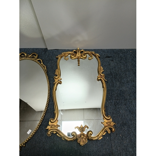 106 - A set of 3 gold gilt mirrors: a small brass port hole style mirror and 2 metal mirrors. The largest ... 