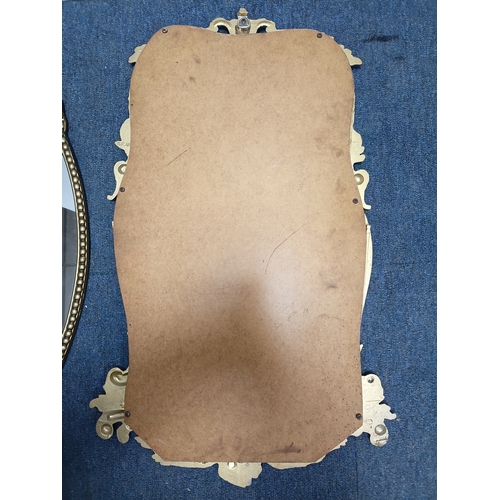 106 - A set of 3 gold gilt mirrors: a small brass port hole style mirror and 2 metal mirrors. The largest ... 