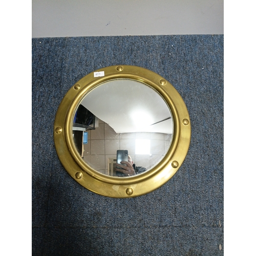 106 - A set of 3 gold gilt mirrors: a small brass port hole style mirror and 2 metal mirrors. The largest ... 