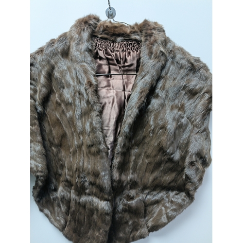 255 - A pair of vintage brown fur stoles with nylon backings