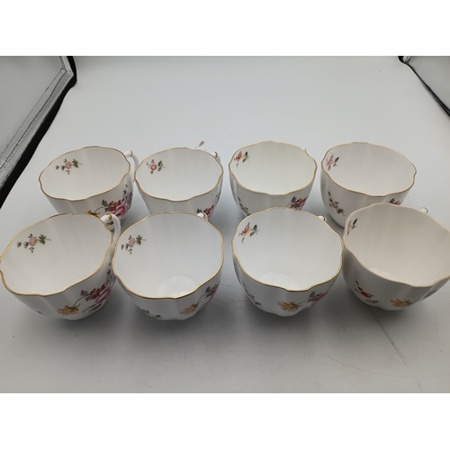 276 - A Royal Crown Derby Tea set. To include, 8 teacups, 1 teapot, 1 milk jug, 1 sandwich plate, 3 plates... 