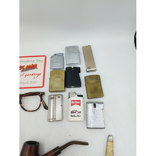 219 - A collection 9 pipes, 9 lighters some of which are Zippo's, a smokers handbook and more.