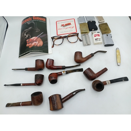 219 - A collection 9 pipes, 9 lighters some of which are Zippo's, a smokers handbook and more.