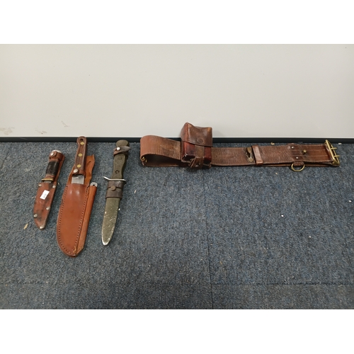 225 - A Sam brown belt with a magazine pouch, a West German commando knife, and 2 other knives in sheaths.