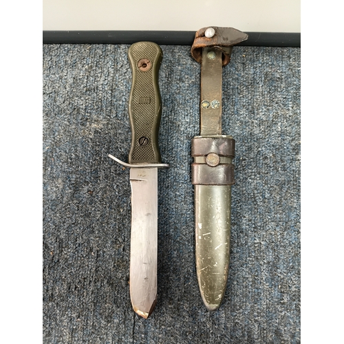225 - A Sam brown belt with a magazine pouch, a West German commando knife, and 2 other knives in sheaths.