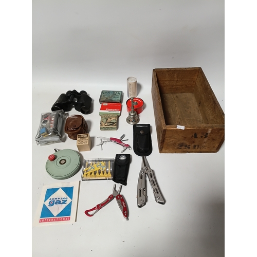 86 - A collection of odds to include, pocket multi tools , tees, plasters, a bell and more.