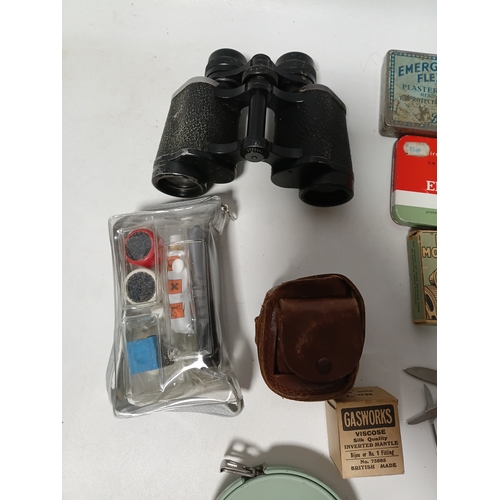 86 - A collection of odds to include, pocket multi tools , tees, plasters, a bell and more.