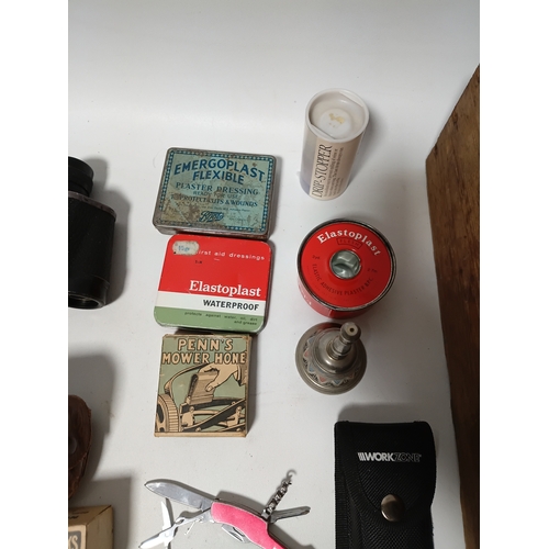 86 - A collection of odds to include, pocket multi tools , tees, plasters, a bell and more.