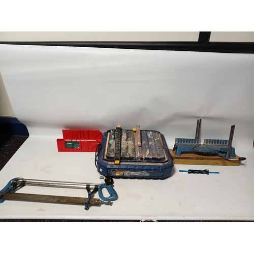 87 - A MacAllister tile cutting machine pat tested and working, plus a saw, a mitre box, and a saw clamp.