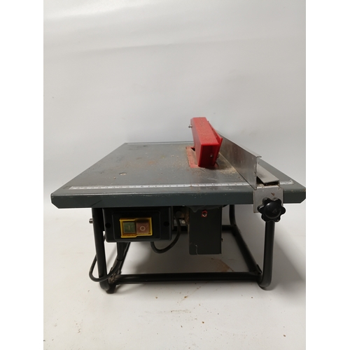 88 - A bench saw, pat tested and working. Height 10 inches x width 20 inches x depth 13 inches.